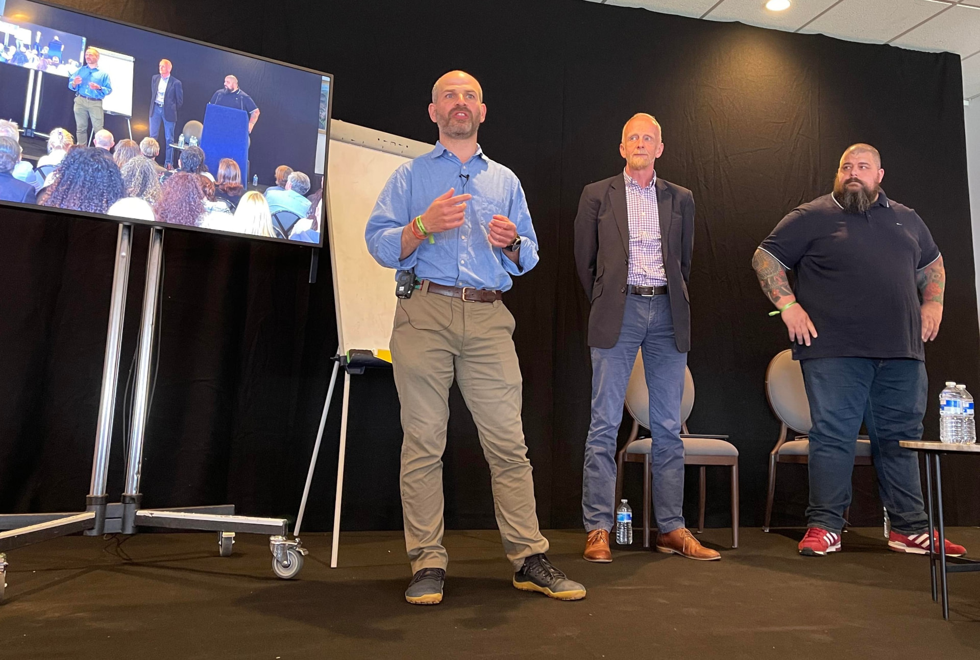 Dave Hill speaking at a workshop alongside two colleagues